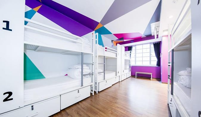 White bunk beds in brightly colored room at Generator Hostel, London