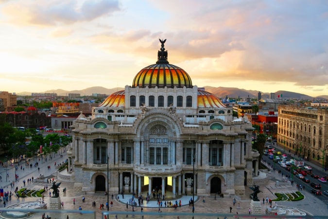 The grand and historic Palacio de Bellas Artes in Mexico City at sunset.