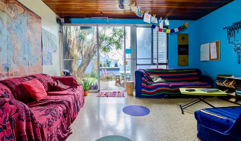 The chill common room with colorful couches at In the Wind Hostel in San José, Costa Rica