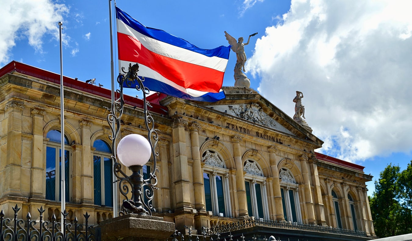 The Costa Rican flag waving in front of the historic theater in San José, Costa Rica