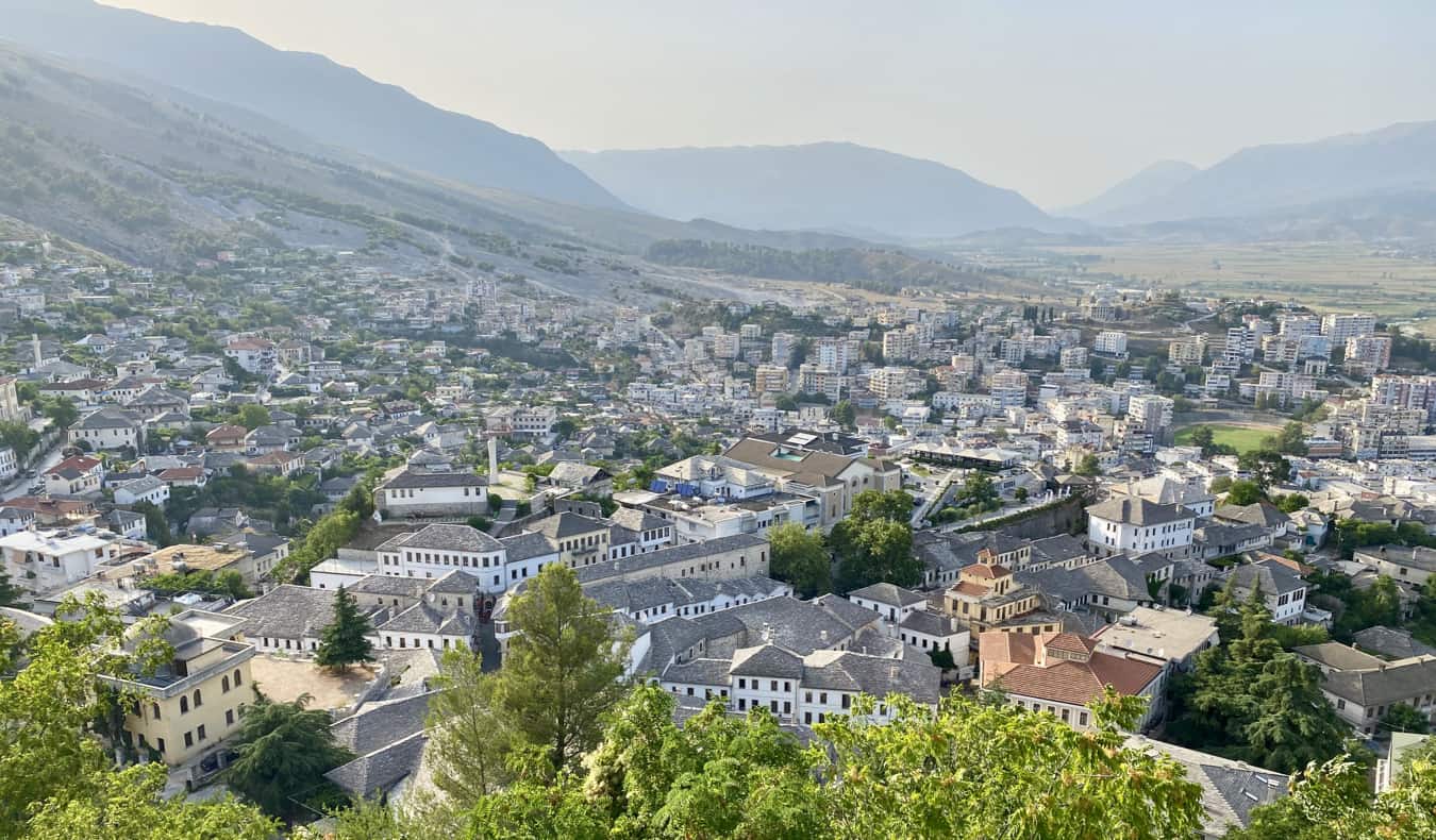 The view overlooking a small town in Albania surrounded by lush mountains