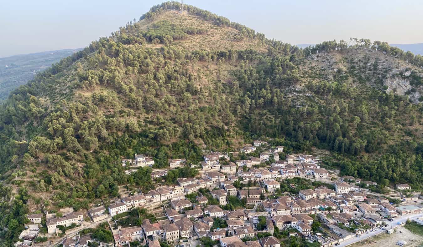 A small village nestled against a mountain in Albania