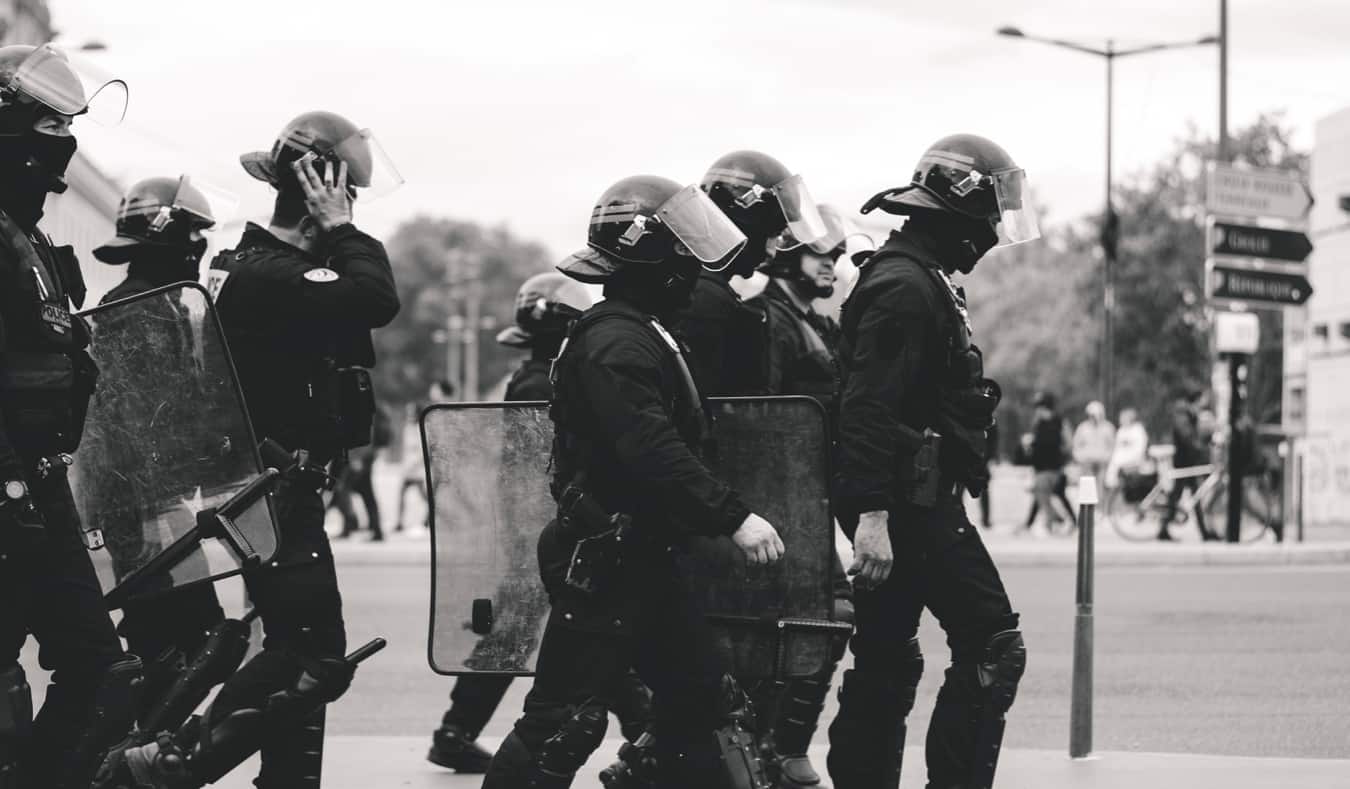 A black and white photo of riot police in Lyon, France