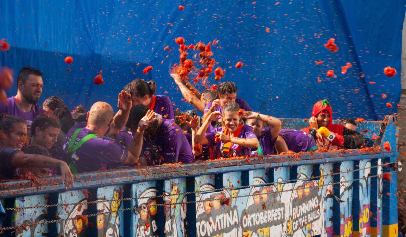 Crowd covered in red tomatoes during the La Tomatina festival in Spain