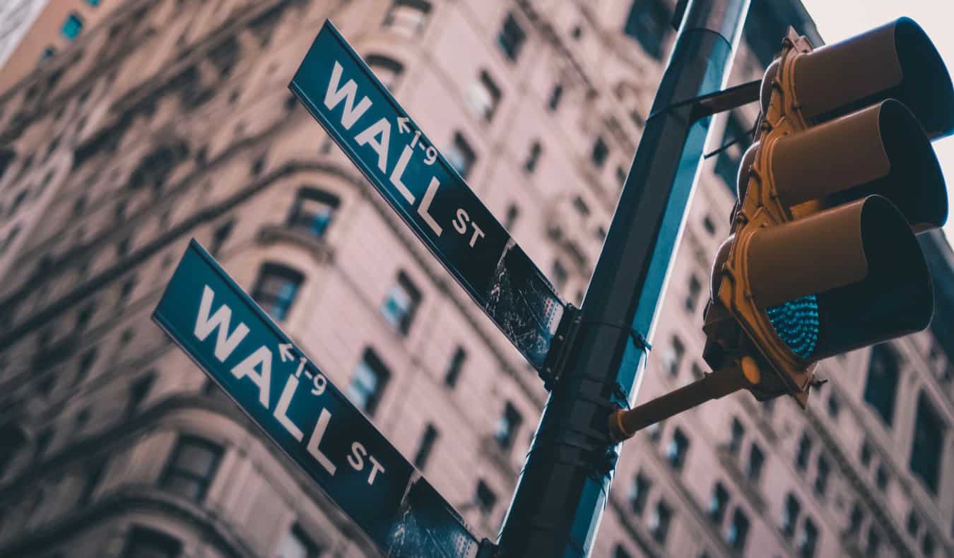Close up of traffic light and Wall Street street sign