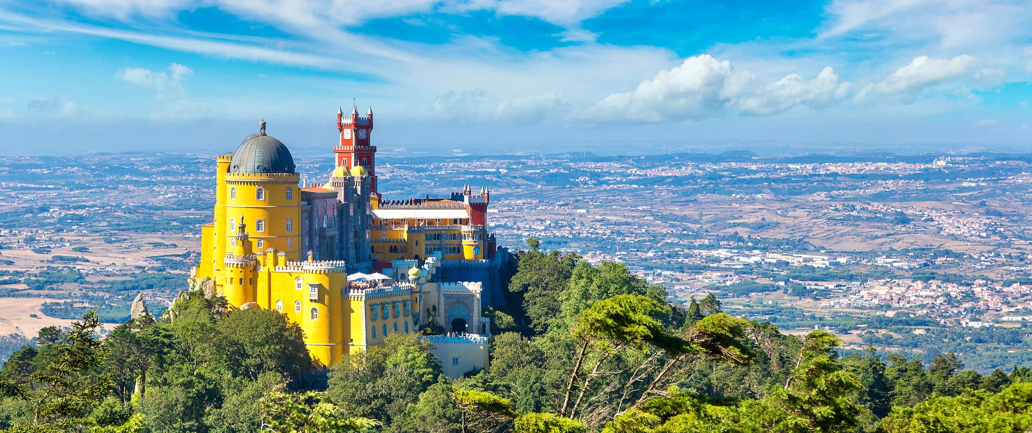 A towering historic building perched on a mountain in Sintra, Portugal