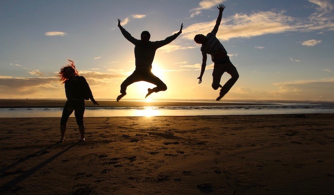 Vegan traveler Chris jumping during a sunset photo in California