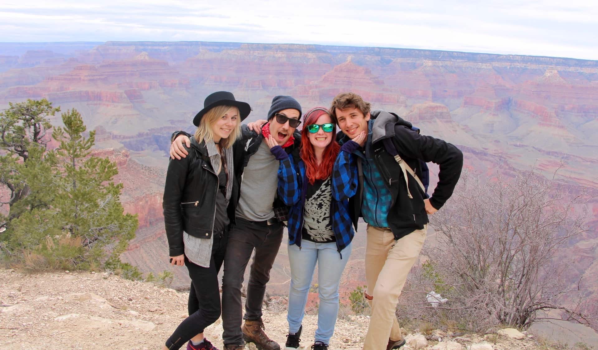 A group of travelers posing for a photo at the Grand Canyon in the USA