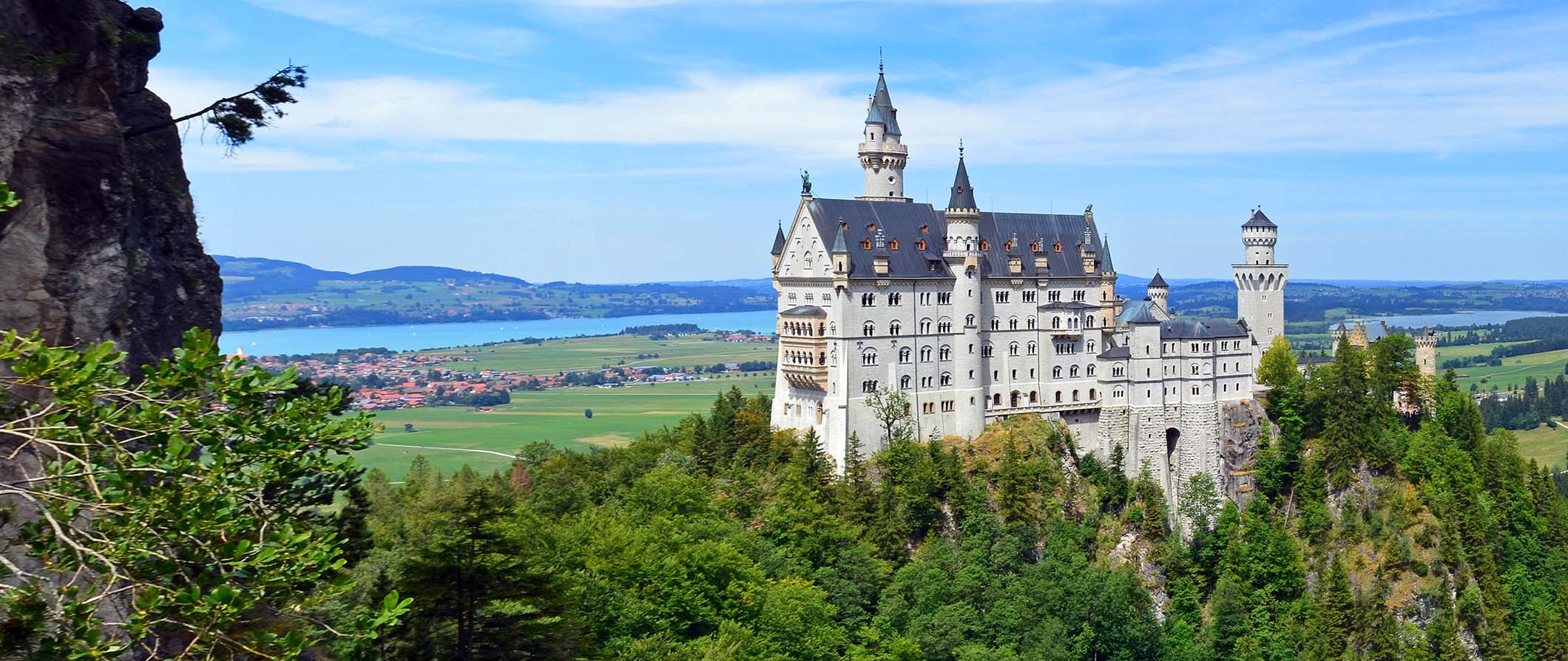 The iconic Neuschwanstein Castle, Germany standing tall over the surrounding greenery in Bavaria