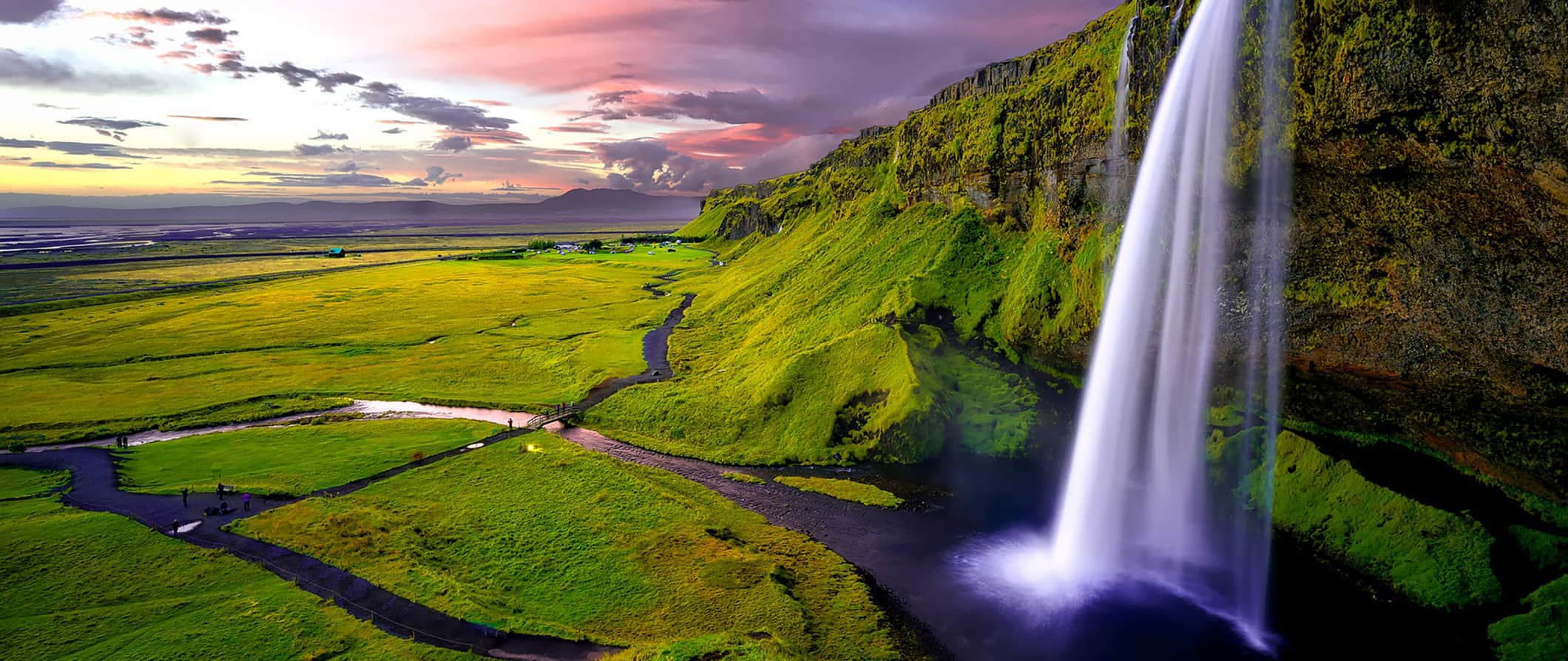 one of Iceland's many waterfalls, at sunset