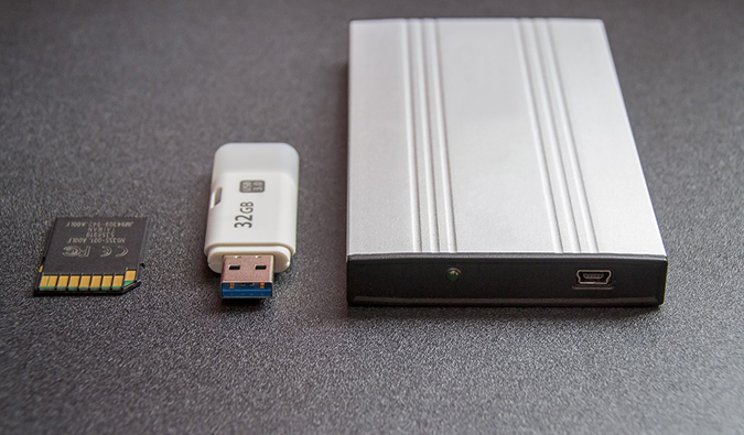 A photo of various backup devices including an external harddrive