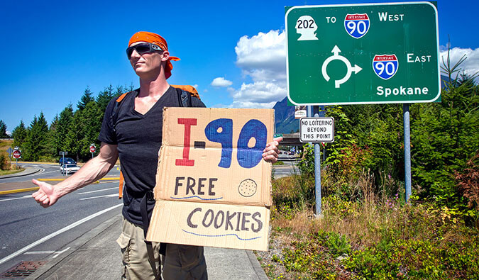 搭顺风车穿越美国的流浪汉专家，牌子上写着免费饼干