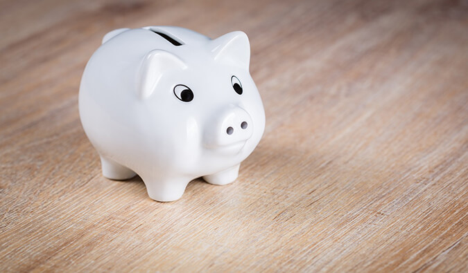 a white piggy bank on a wooden floor