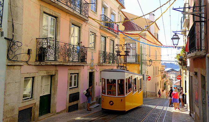 a yellow tram on the cobbled streets of Lisbon