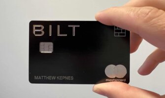 Nomadic Matt's Bilt Mastercard being held up in front of a white wall